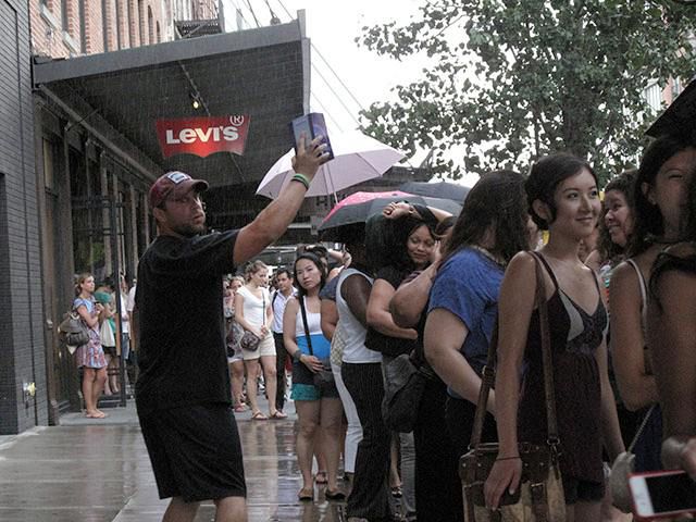 People were smiling on line even once the rain started to get them wet.